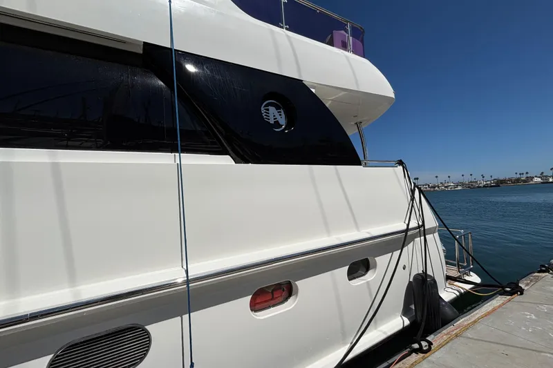 Luxury Norseman 80 yacht docked by the water, 2010 model, sunny day.