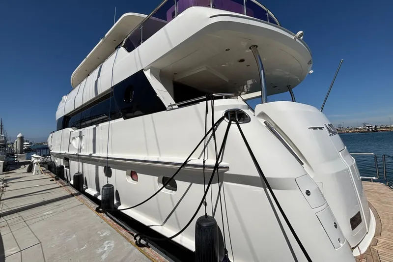 Luxury 2010 Norseman 80 yacht docked at marina under clear blue sky.