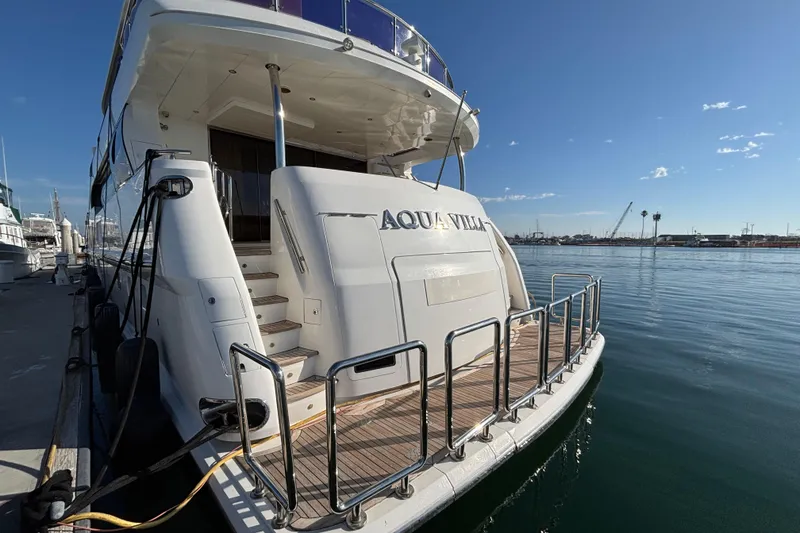 Luxury yacht Norseman 80, 2010 model, docked at marina with clear blue sky.