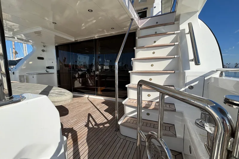 Luxurious Norseman 80 yacht deck with wooden flooring and elegant staircase, 2010 model.