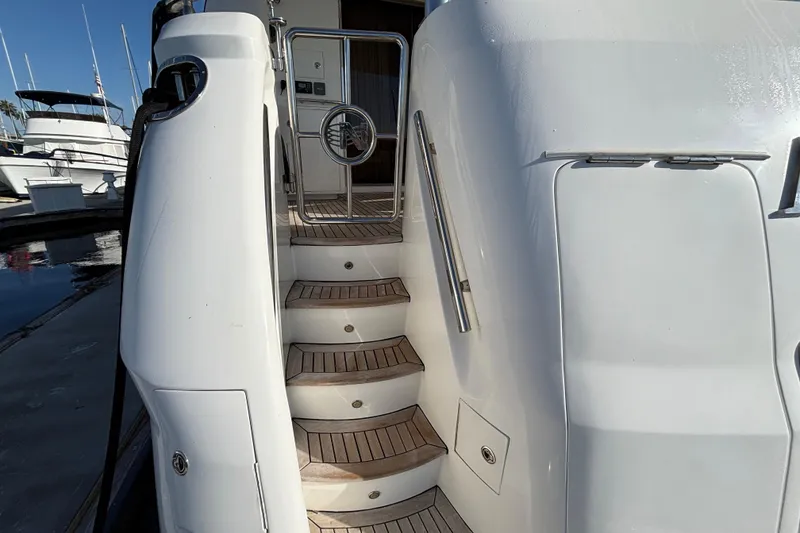 Staircase on a 2010 Norseman 80 yacht, featuring sleek design and wooden steps.
