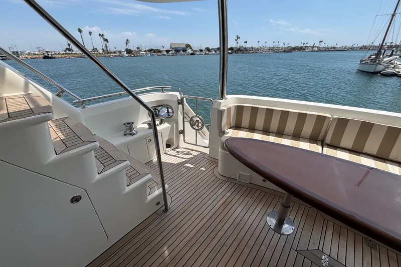 Luxurious 2010 Norseman 80 yacht deck with seating, table, and ocean view.