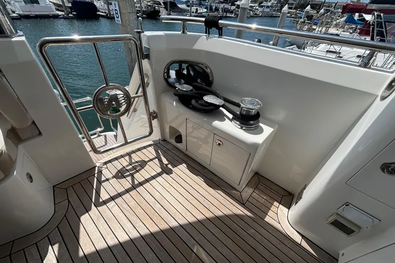 Deck area of 2010 Norseman 80 yacht with winch and railing, docked at marina.