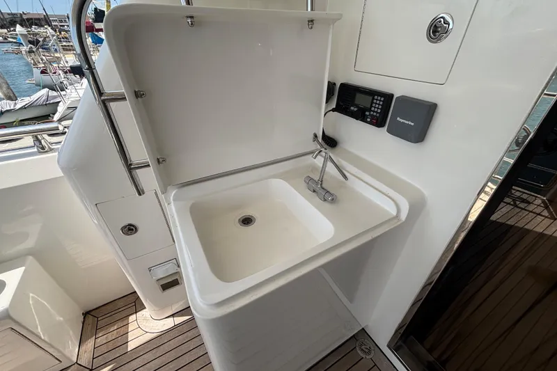 Boat sink area on 2010 Norseman 80 yacht, featuring a faucet and marine electronics.