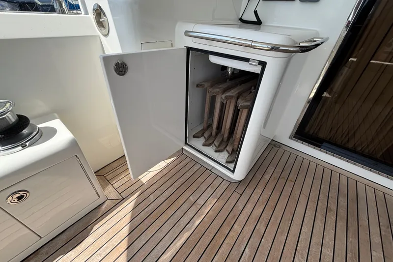 Open storage compartment on 2010 Norseman 80 yacht with wooden deck flooring.