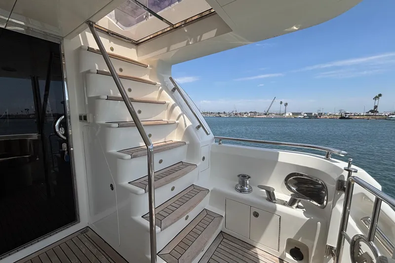 Staircase on 2010 Norseman 80 yacht with ocean view and marina background.