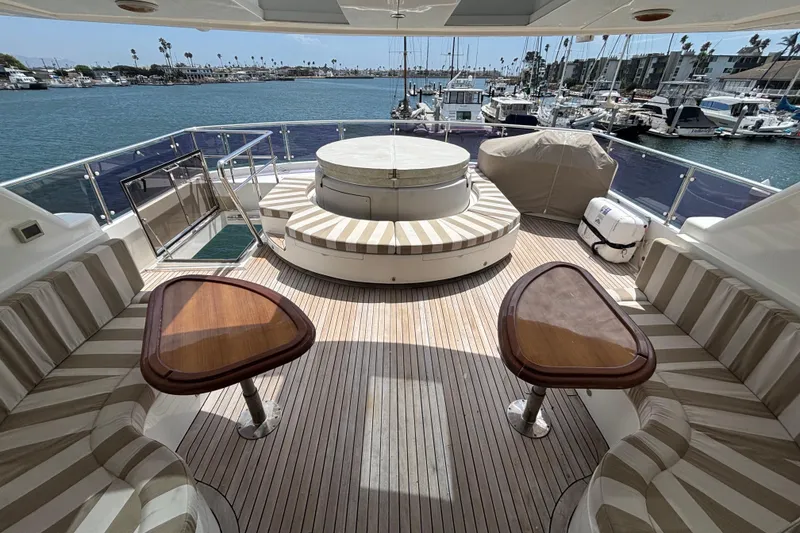 Luxurious 2010 Norseman 80 yacht deck with seating, tables, and marina view.