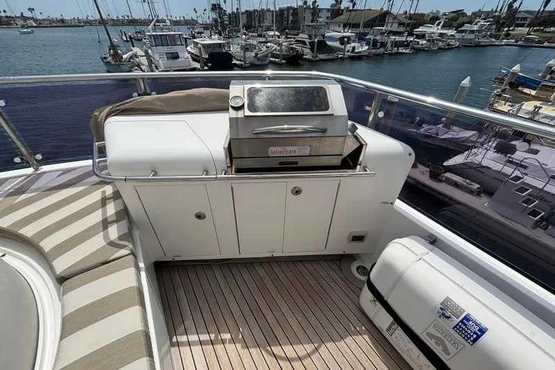 Outdoor grill on 2010 Norseman 80 yacht deck, overlooking marina with boats.
