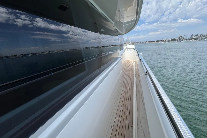 Side deck view of 2010 Norseman 80 yacht with ocean and sky reflections.