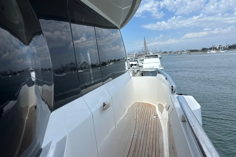 Side view of 2010 Norseman 80 yacht on calm water, reflecting sky and marina.