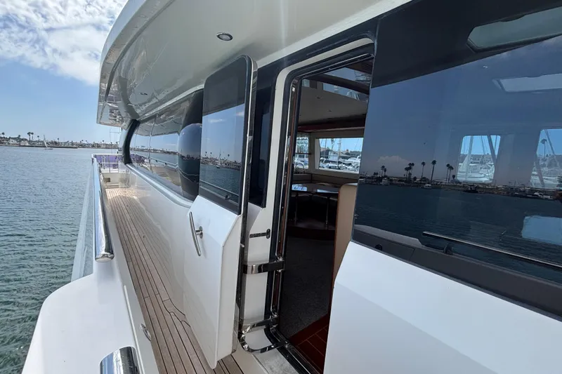 Norseman 80 yacht, 2010 model, featuring sleek exterior and open cabin door by the water.