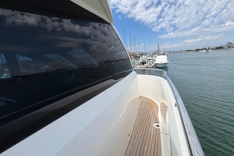 2010 Norseman 80 yacht docked at marina, reflecting sky and water.