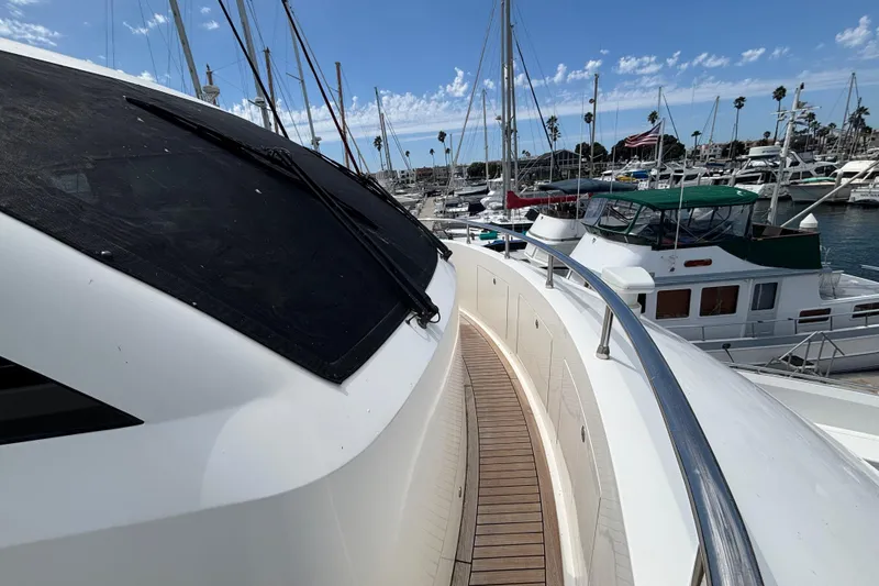 2010 Norseman 80 yacht docked in marina, surrounded by sailboats under blue sky.