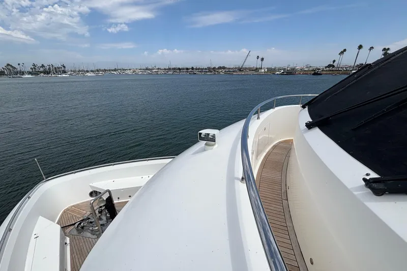 Front deck view of 2010 Norseman 80 yacht, overlooking calm waters and distant marina.