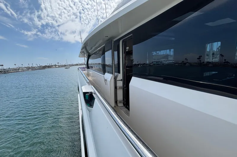 Side view of 2010 Norseman 80 yacht on calm water under a partly cloudy sky.