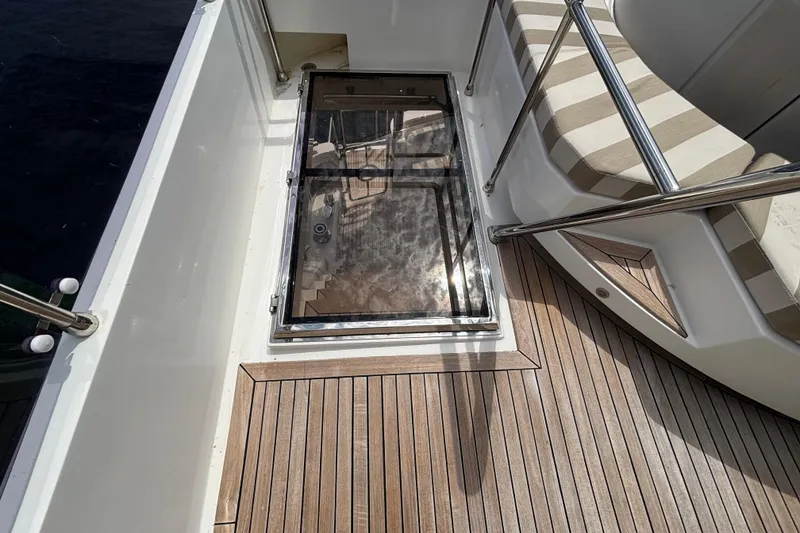 Norseman 80 yacht deck with glass hatch and striped seating, 2010 model.