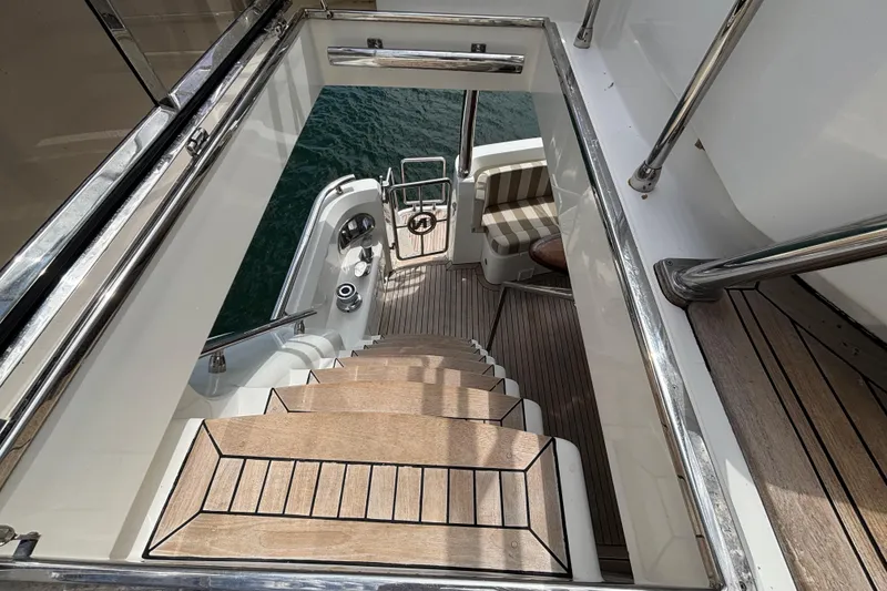 Staircase on Norseman 80 yacht, 2010 model, leading to lower deck with water view.