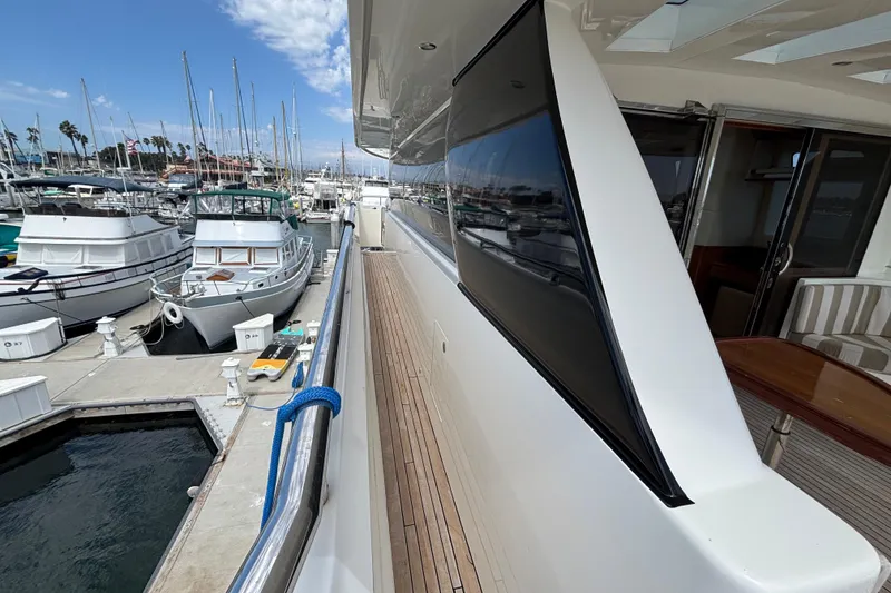 Luxury 2010 Norseman 80 yacht docked at marina with clear blue sky.