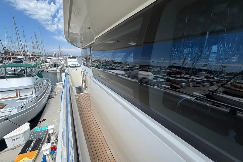 Norseman 80 yacht docked at marina, reflecting boats and clear sky, 2010 model.