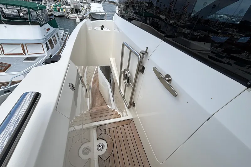 Stairway on 2010 Norseman 80 yacht, featuring sleek design and wooden steps.