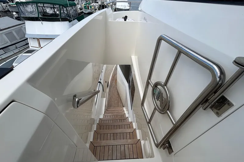 Staircase on 2010 Norseman 80 yacht with sleek design and stainless steel railing.