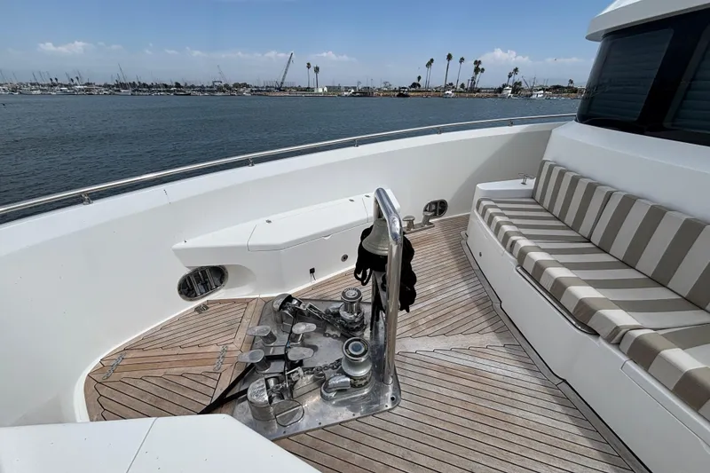 Bow view of 2010 Norseman 80 yacht with striped seating and teak deck.