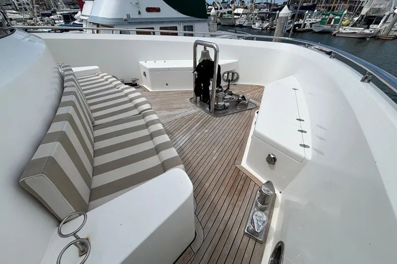 Deck of 2010 Norseman 80 yacht with striped seating and wooden flooring.
