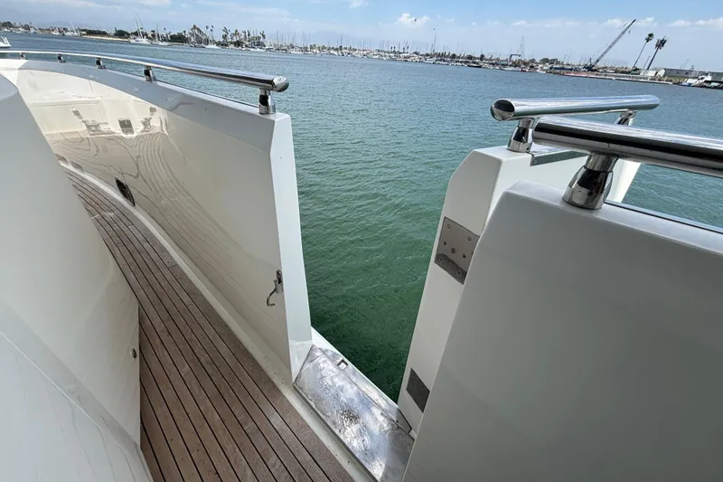 Side deck of 2010 Norseman 80 yacht with wooden flooring and stainless steel railings.