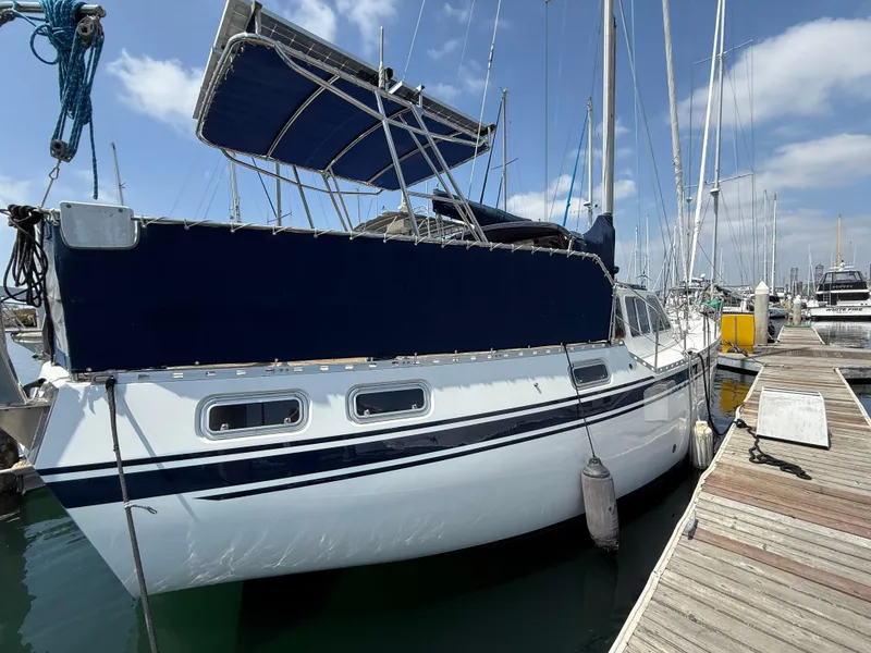 1985 Nauticat 43 sailboat docked at marina under clear blue sky.
