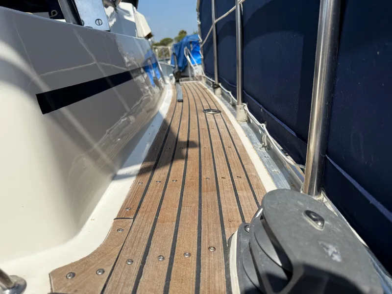 Teak deck of 1985 Nauticat 43 sailboat with stainless steel railing.