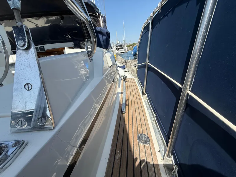 Nauticat 43 sailboat deck with wooden flooring and blue canvas, 1985 model.