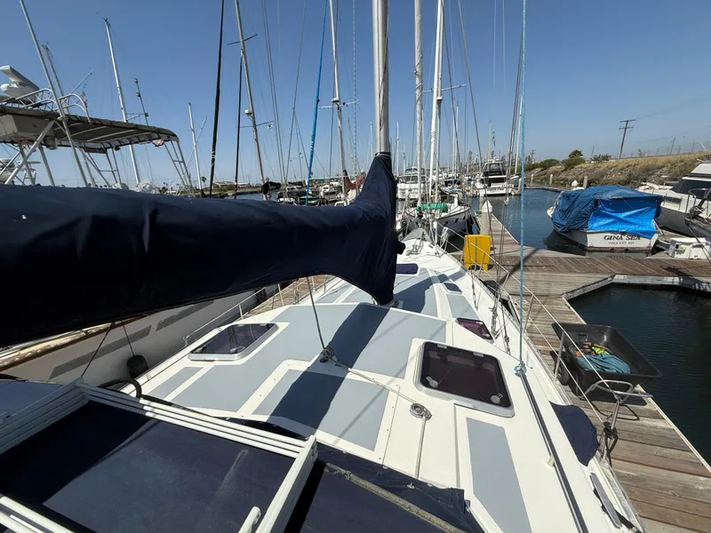 1985 Nauticat 43 sailboat docked at marina, showcasing deck and mast under clear blue sky.