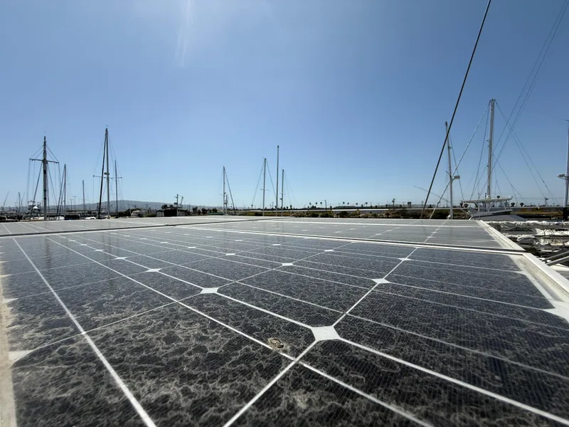 Solar panels on a 1985 Nauticat 43 sailboat under clear blue sky.