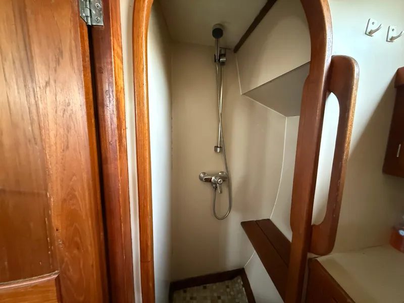 Shower area in 1985 Nauticat 43 sailboat with wooden accents and compact design.