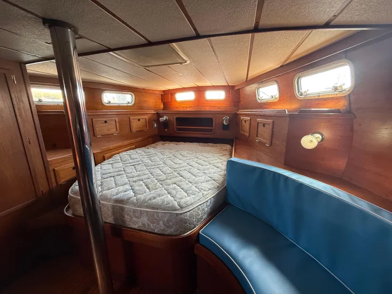 Interior of 1985 Nauticat 43 sailboat cabin with bed and seating area.