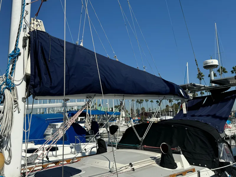 1989 Catalina Sloop sailboat docked in a marina under clear blue skies.