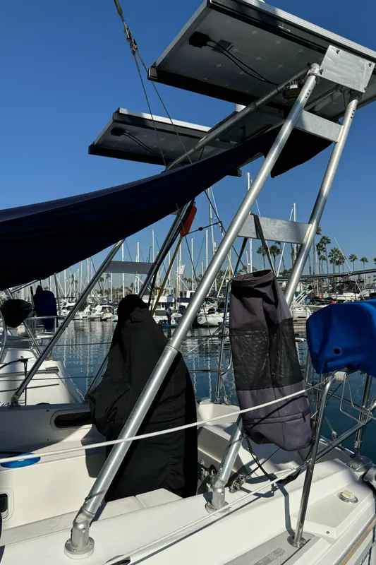 1989 Catalina Sloop with solar panels docked at a marina.