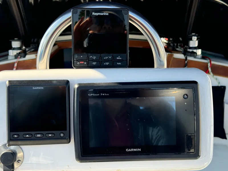 Cockpit of 1989 Catalina Sloop with Garmin and Raymarine navigation systems.