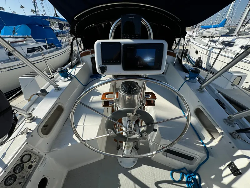 Cockpit of a 1989 Catalina Sloop with steering wheel and navigation equipment.