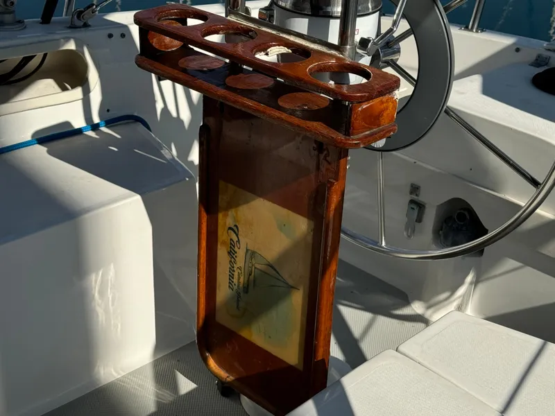 1989 Catalina Sloop cockpit with wooden cup holder and steering wheel.