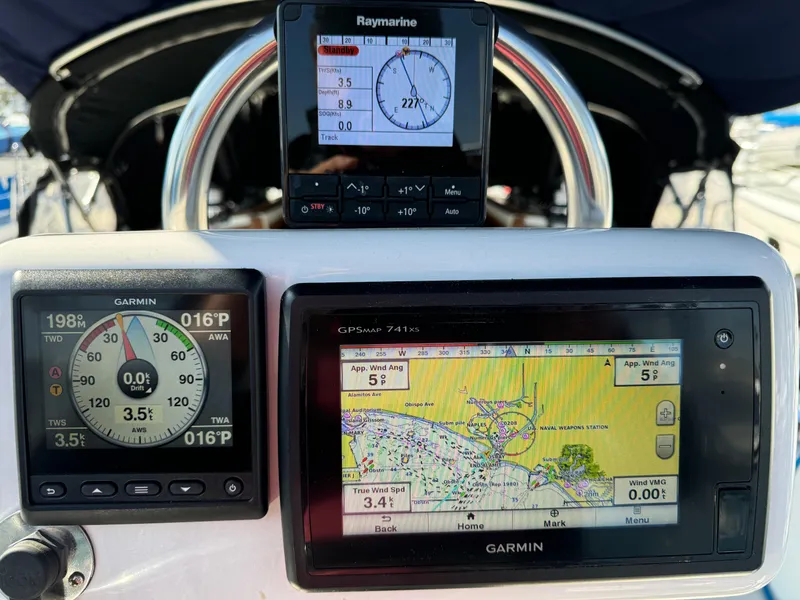 Navigation instruments on a 1989 Catalina Sloop, featuring Garmin and Raymarine displays.