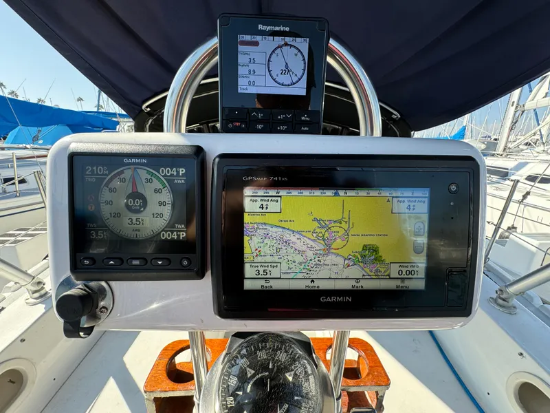 Cockpit of 1989 Catalina Sloop with Garmin navigation displays and Raymarine instruments.