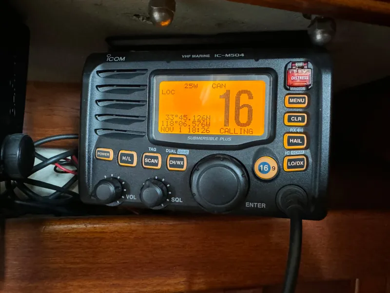 VHF marine radio on 1989 Catalina Sloop, channel 16 active, wooden interior.