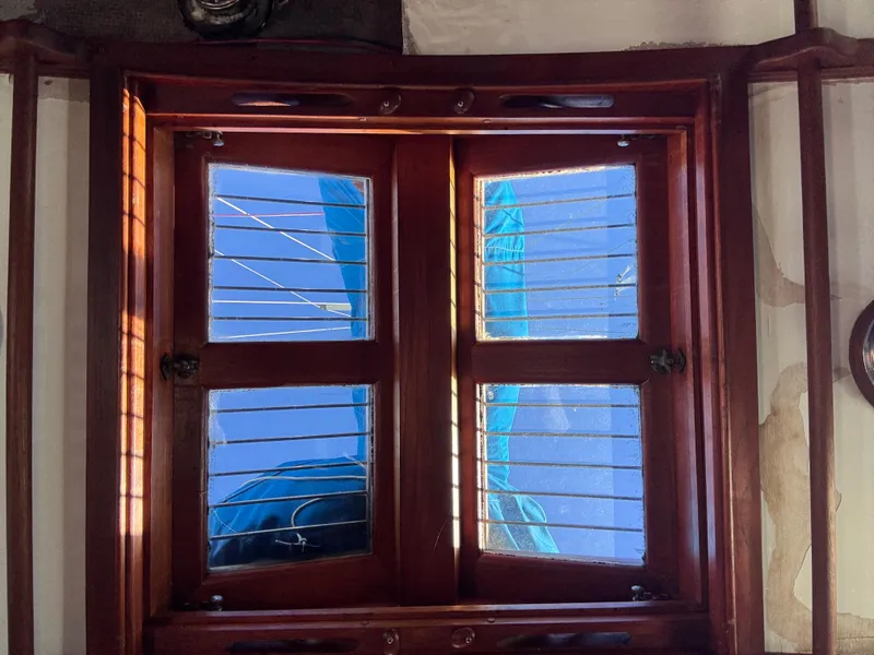 Wooden boat window with blue sky view, Baba 30 model, 1977.
