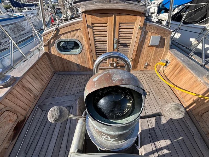 Vintage 1977 Baba 30 sailboat cockpit with wooden details and compass.