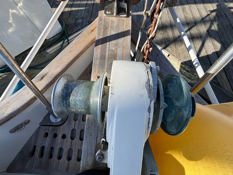 Deck of 1977 Baba 30 sailboat with anchor windlass and chain.