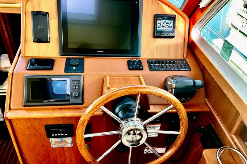 2016 Sabre 38 Salon Express helm with Garmin display and wooden steering wheel.