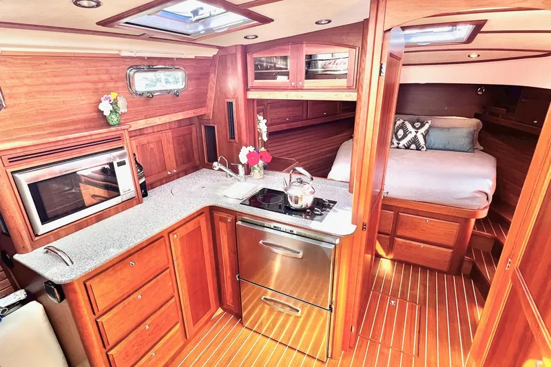 Interior of 2016 Sabre 38 Salon Express yacht with modern kitchen and cozy bedroom.