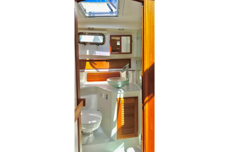 Interior of 2016 Sabre 38 Salon Express yacht bathroom with skylight and wooden accents.