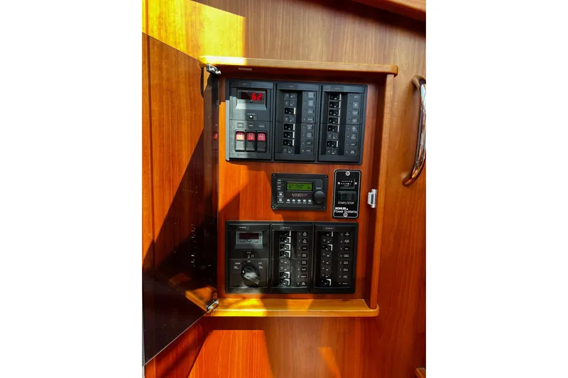 Electrical panel of 2016 Sabre 38 Salon Express yacht with wooden finish.